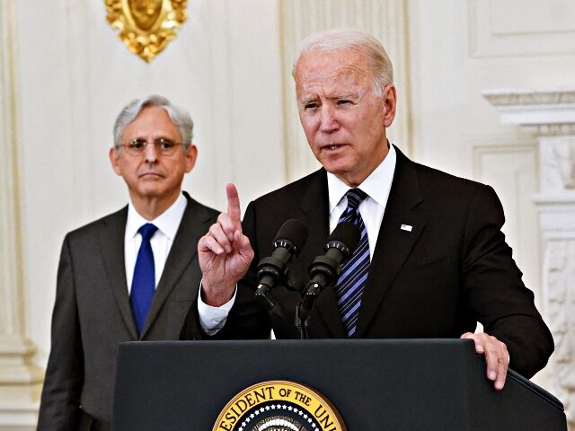 Attorney General Merrick Garland looks on as US President Joe Biden speaks about crime pre