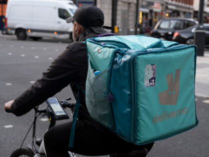 Deliveroo food delivery rider / cycle courier waiting at traffic lights on New Oxford Street on 22nd November 2021 in London, United Kingdom. Deliveroo is an online food delivery company founded by William Shu in 2013 in London, England. (photo by Mike Kemp/In Pictures via Getty Images)