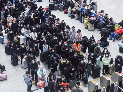 Passengers crowd Hangzhou East Railway Station during the peak travel period ahead of the