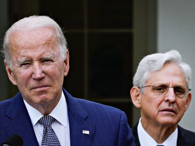 WASHINGTON, DC - MAY 13: Attorney General Merrick Garland looks on as U.S. President Joe Biden speaks in the Rose Garden of the White House on May 13, 2022 in Washington, DC. The event was held to highlight state and local leaders who are investing in American Rescue Plan funding …