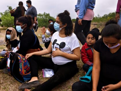 LA JOYA, TEXAS - APRIL 13: Pregnant women sit with their families while waiting to board a
