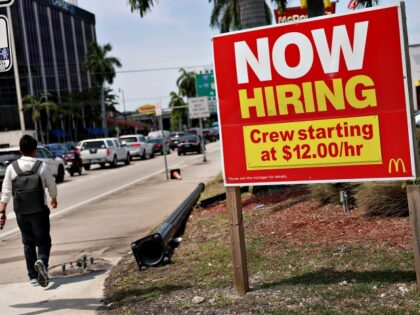 MIAMI, FLORIDA - MAY 05: A 'Now Hiring' sign posted outside of a restaurant look