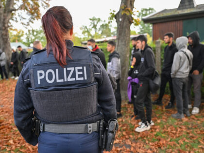 11 October 2023, Brandenburg, Forst: Illegal migrants are guarded by a female officer of t