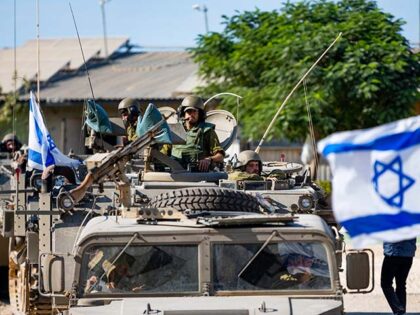 IDF Soldiers ride in armored personnel carriers on October 17, 2023 in Be'eri, Israel