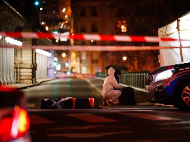 TOPSHOT - A forensic police officer works at the scene of a stabbing in Paris on December
