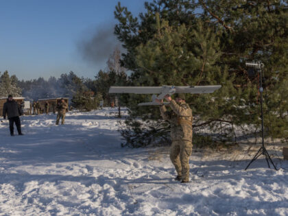 A Ukrainian serviceman prepares to launch a drone during a military training which focuses