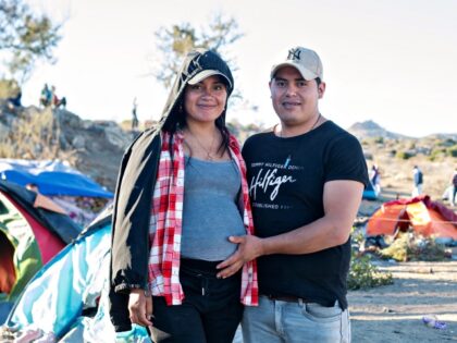 Carla Morocho (L), 8 months pregnant, and her husband Christian pose near the US-Mexico bo