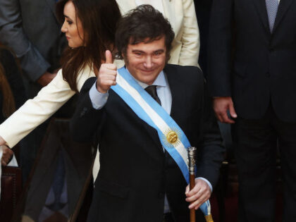 Argentina's new president Javier Milei gives the thumb up next to his vice-president Victo
