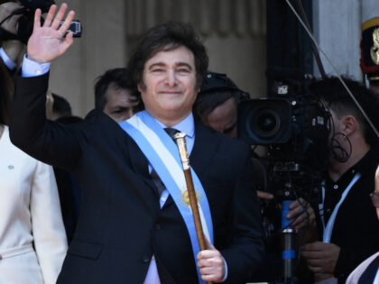Argentina's new president Javier Milei waves next to his vice president Victoria Villarrue