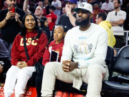 Lakers' LeBron Jame watches the game between the USC Trojans and the Long Beach State 49er