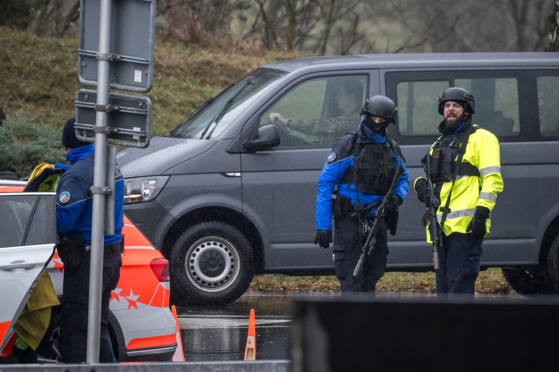 Police officers control cars near Saint Maurice, as they search for a gunman who killed two people and injured another in the southern Swiss town of Sion, on December 11, 2023. Police said a man fired shots at people in two distinct locations in the picturesque town in the Alpine Wallis region shortly before 8 am (0700 GMT). (Photo by Fabrice COFFRINI / AFP) (Photo by FABRICE COFFRINI/AFP via Getty Images)
