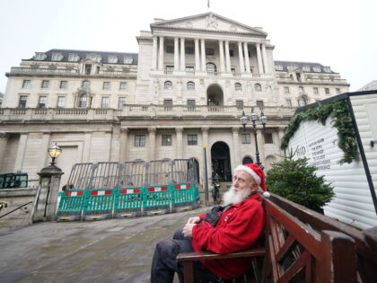 Gerard White, wearing a Santa hat and waiting for his wife to finish work, sitting outside