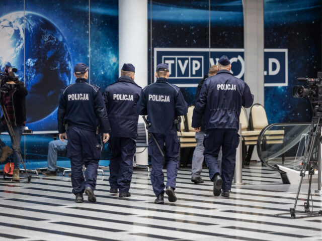 A group of police officers are seen entering the headquarters of Polish Public TV in Warsa