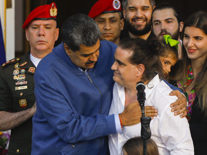 The president of the Bolivarian Republic of Venezuela, Nicolas Maduro (L), receives busine