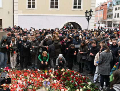 People mourn at a makeshift memorial for the victims outside the Charles University in cen