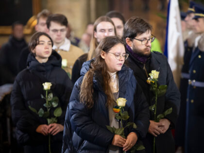 PRAGUE, CZECH REPUBLIC - DECEMBER 23: Students bring flowers for each late victim during a
