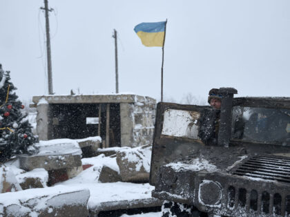BAKHMUT REGION, UKRAINE - DECEMBER 25: Ukrainian soldiers passing by in a HMMWV stop to ta