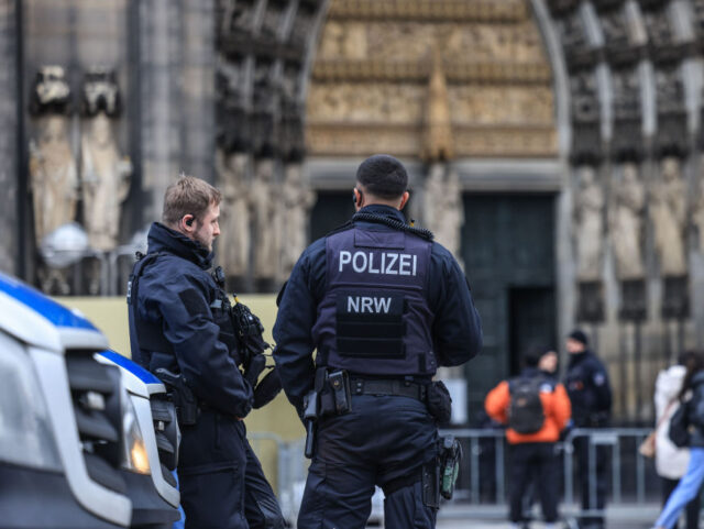 27 December 2023, North Rhine-Westphalia, Cologne: Police officers stand in front of the cathedral. Cologne Cathedral remains closed to visitors after the terror alert. Photo: Oliver Berg/dpa (Photo by Oliver Berg/picture alliance via Getty Images)
