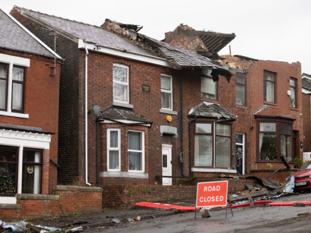 STALYBRIDGE, ENGLAND - DECEMBER 28: Roofs can be seen ripped off homes on Hough Hill Road