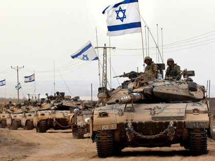 Israeli Merkava tanks drive near the border between Israel and the Gaza Strip as they retu