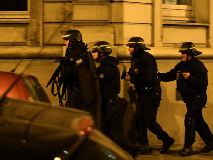 TOPSHOT - Police officers patrol near the site of a shooting at the Champs Elysees in Pari