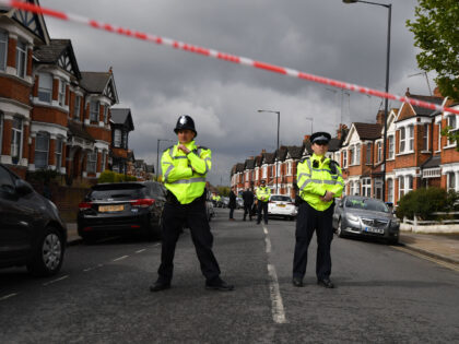 TOPSHOT - British police officers secure a cordon in a residential street in north-west Lo