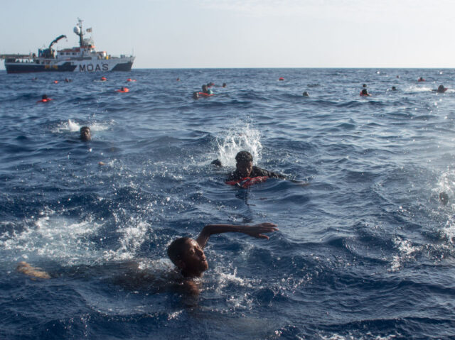 LAMPEDUSA, ITALY - MAY 24: Refugees and migrants are seen swimming and yelling for assita