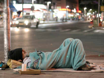 A homeless man is sleeping in the street (Stock photo via Getty).