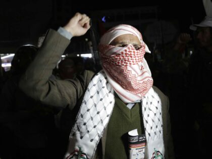 SANA'A, YEMEN - DECEMBER 09: Protestors loyal to the Houthi movement lift their rifle