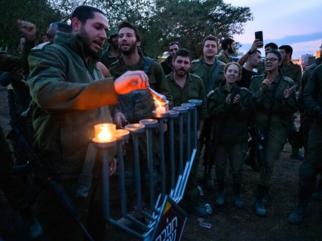 SOUTHERN ISRAEL - DECEMBER 07: IDF soldiers light Hanukkah candles on the first night of H