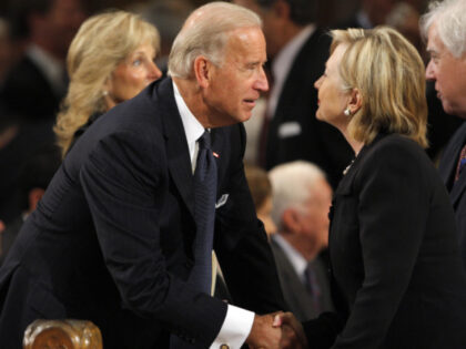 Vice President Joseph Biden (L) talks with Secretary of State Hillary Clinton as they awai