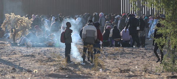 Migrants gather around fire to keep warm in near freezing temperatures. (Randy Clark/Breitbart Texas)