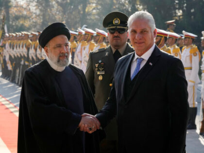 Cuban President Miguel Díaz-Canel, right, is welcomed by his Iranian counterpart Ebrahim