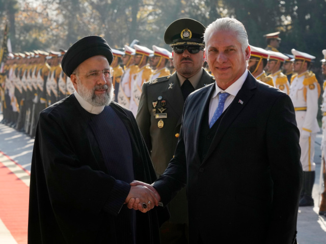 Cuban President Miguel Díaz-Canel, right, is welcomed by his Iranian counterpart Ebrahim Raisi during his official welcoming ceremony at the Saadabad Palace in Tehran, Iran, Monday, Dec. 4, 2023. (AP Photo/Vahid Salemi)