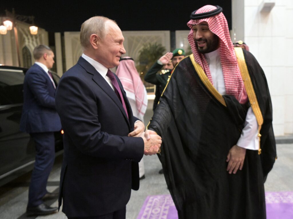 This pool photograph distributed by Russian state agency Sputnik shows Russia's President Vladimir Putin shaking hands with Saudi Crown Prince Mohammed bin Salman ahead of their talks in Riyadh on December 6, 2023. (Photo by Alexey NIKOLSKY / POOL / AFP)
