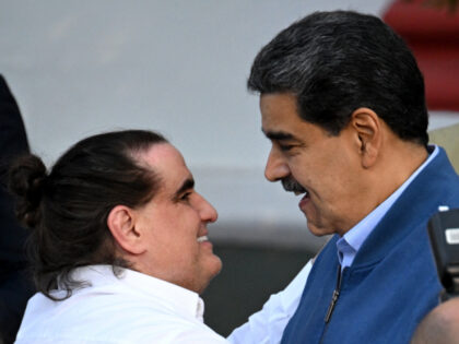 TOPSHOT - Venezuela's President Nicolas Maduro (R) welcomes Colombian businessman Alex Saa