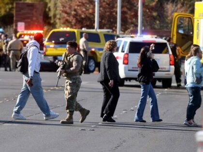 Police evacuate students on Harmon Avenue near Maryland Parkway after a shooting on the UN