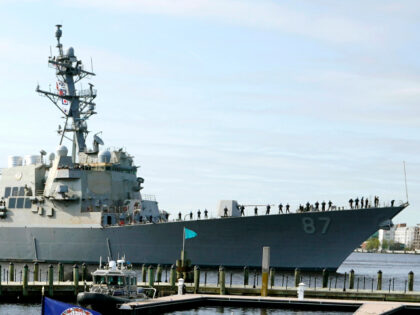 File - The USS Mason, an Arleigh Burke-class destroyer, passes a dock in Norfolk, Va., Apr