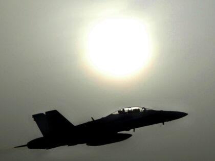 ARABIAN GULF - MARCH 21: An F-18 fighter jet takes off through the dusty sunlight on a mis