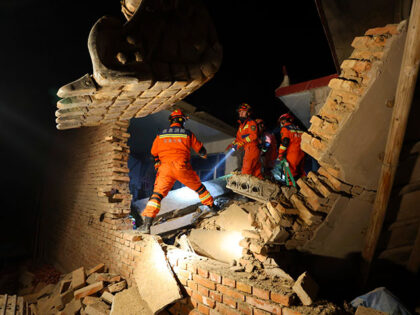 Rescuers work on the rubble of a house that collapsed in the earthquake in Kangdiao villag