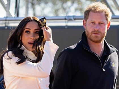 FILE - Prince Harry and Meghan Markle Duke and Duchess of Sussex visit the track and field