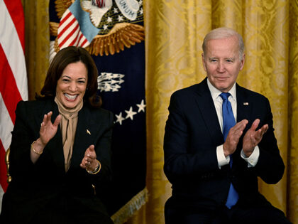US Vice President Kamala Harris and US President Joe Biden applaud during an event marking