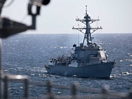 Arleigh Burke-class guided-missile destroyer USS Gravely (DDG 107) sails alongside the Was