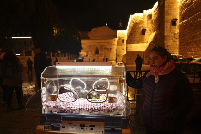 An art installation in front of the Church of the Nativity in Bethlehem depicts the baby J