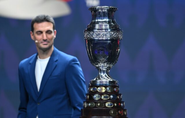 Argentina coach Lionel Scaloni eyes the Copa America trophy during the final draw for the