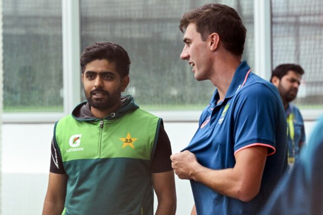 Australia captain Pat Cummins (R) chats with Pakistan batsman Babar Azam at the Melbourne