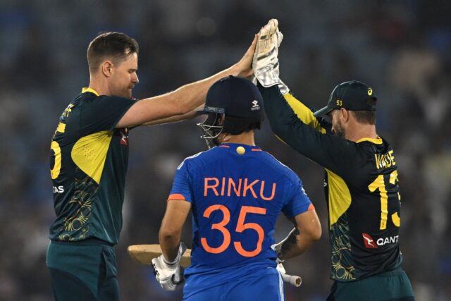 Australia's Jason Behrendorff (L) celebrates with captain Matthew Wade after taking the wi