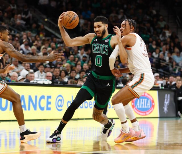 Boston's Jayson Tatum, at left driving to the hoop against San Antonio's Tre Jones, scored