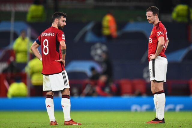 Bruno Fernandes and Jonny Evans look on after Manchester United were eliminated from the C