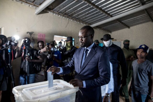 Jailed Senegalese opposition figure Ousmane Sonko (C) finished third in the 2019 president